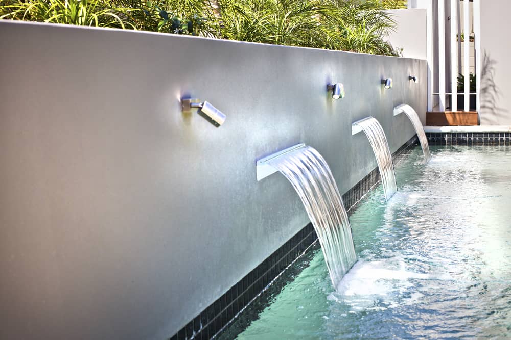 Small waterfall With modern swimming pool