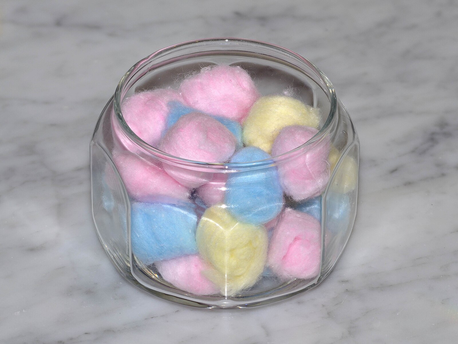 A jar of colorful cotton balls