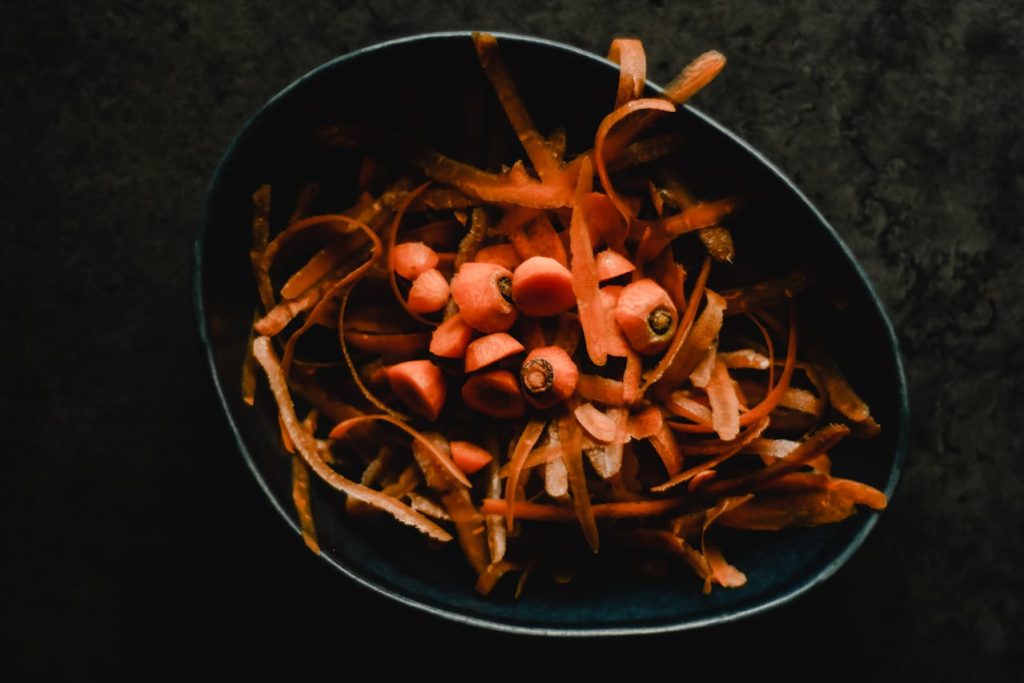 Kitchen scraps in a black bin for composting